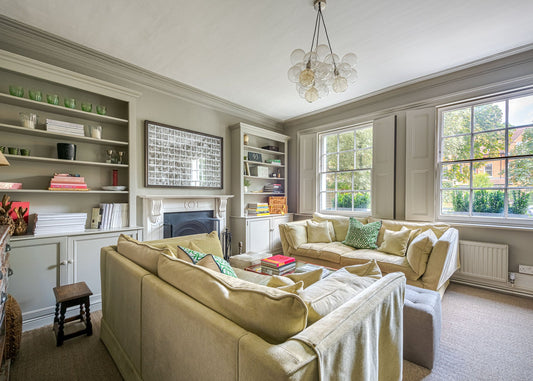 Living room with beige sofa, coffee table, and decorative items.